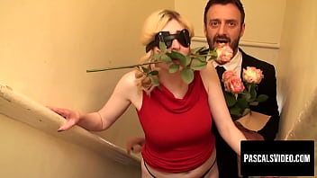 A Sultry Blonde Temptress, A Rose Clamped Between Her Lips And A Blindfold Veiling Her Eyes, Ready For A Night Of Wild, Forbidden Romance.
